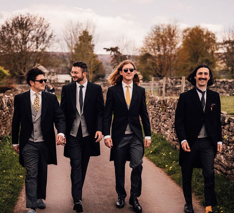 Groomsmen wedding group photo in morning suits and sunglasses 