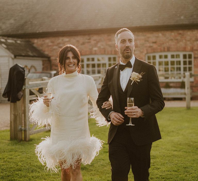 Sunset wedding photos of bride in short modern wedding dress with groom in black tie at Larkspur Lodge wedding 