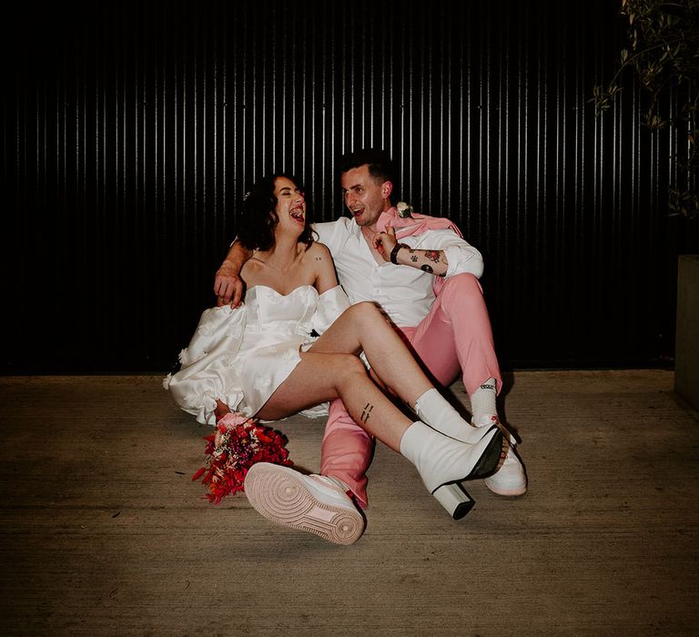 The Shack Revolution wedding with the bride and groom laughing together in flash photo 