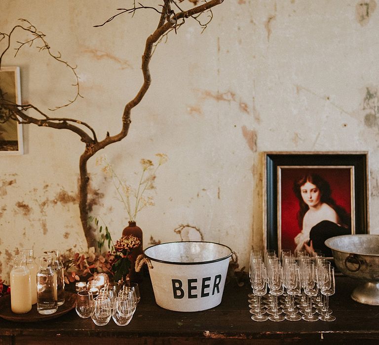 Wedding drinks station with ice bucket and glasses for both alcoholic and non-alcoholic beverages 