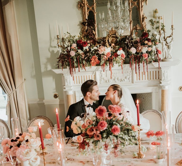 Prestwold Hall wedding venue with pink and red candles and flower arrangements 