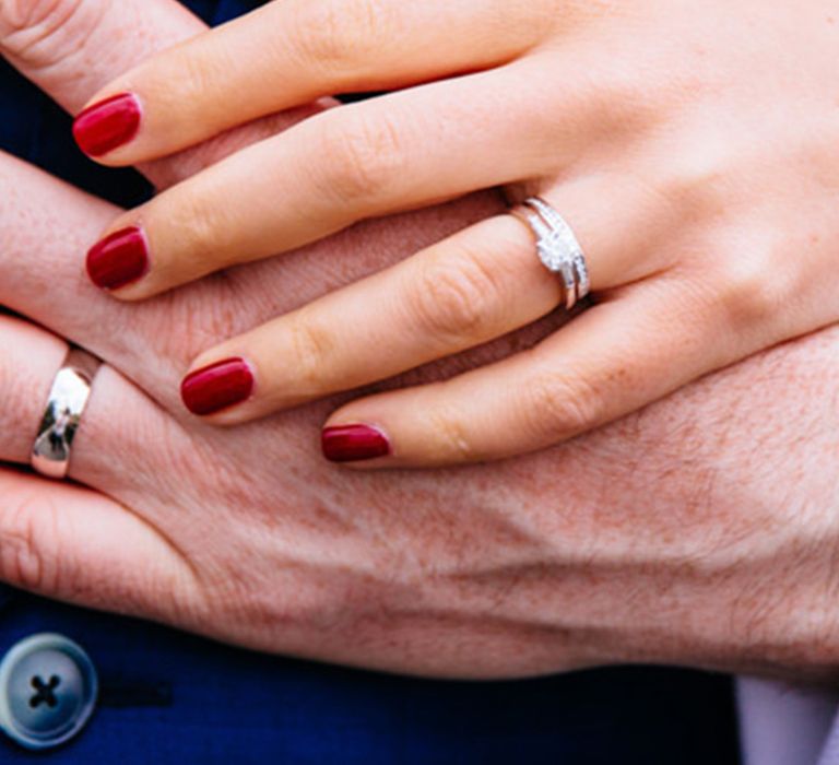 Bride with short squoval deep red wine shade coloured wedding nails with silver wedding and engagement nails 