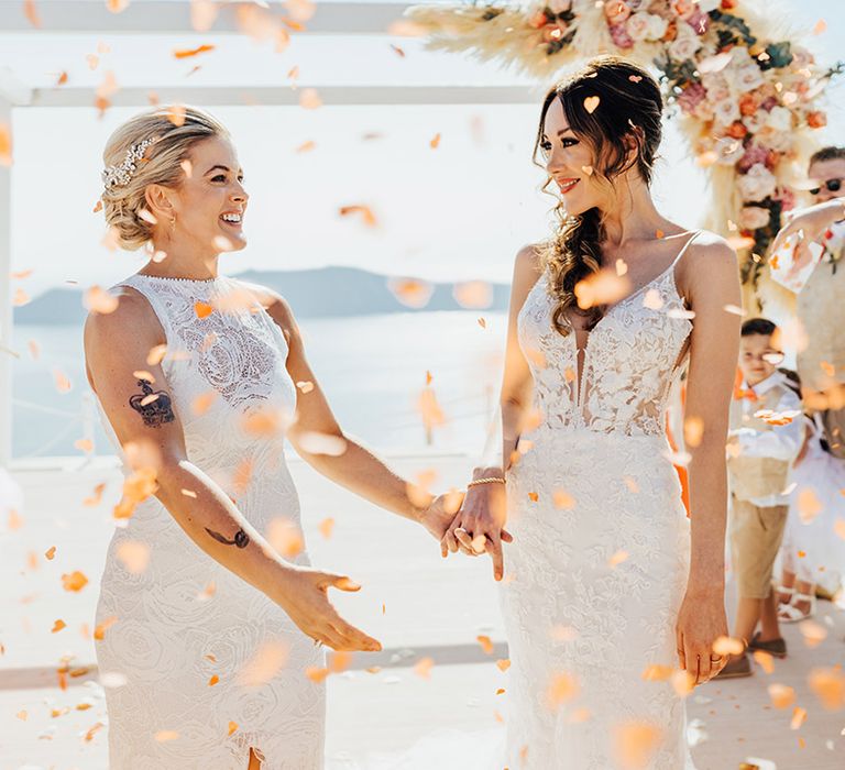 Colourful confetti exit for two brides at Santorini same sex LGBTQIA+ wedding 