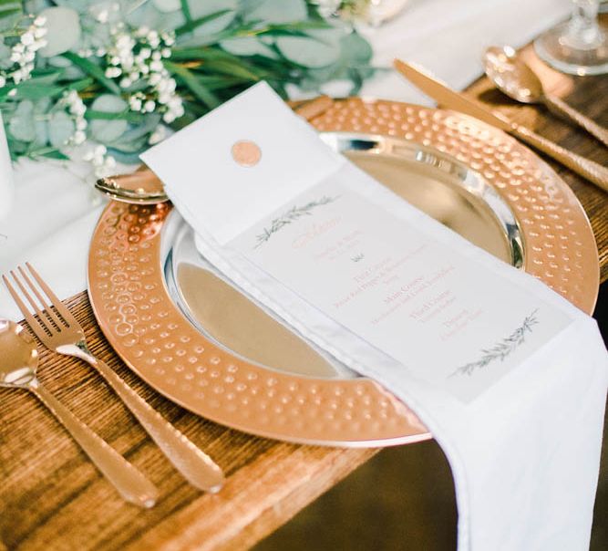 Copper table platters at place setting 