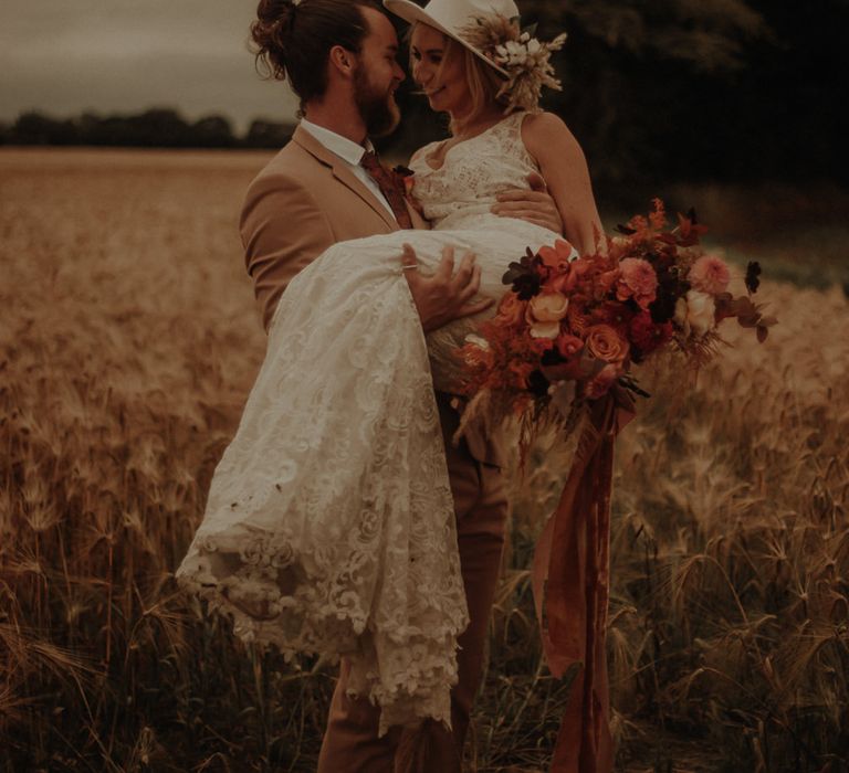 Boho bride and groom portrait in a field by Esme Whiteside Photography