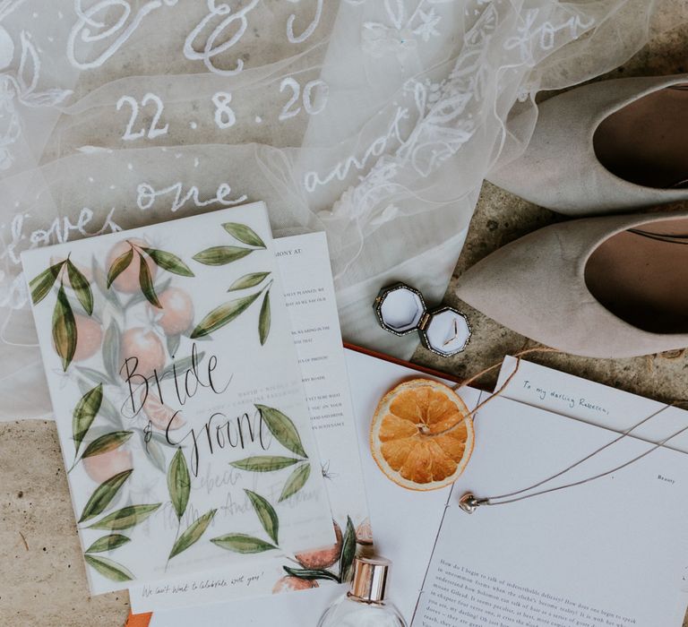 Bridal accessories and wedding stationery for wedding reception at home with orange wedding decorations