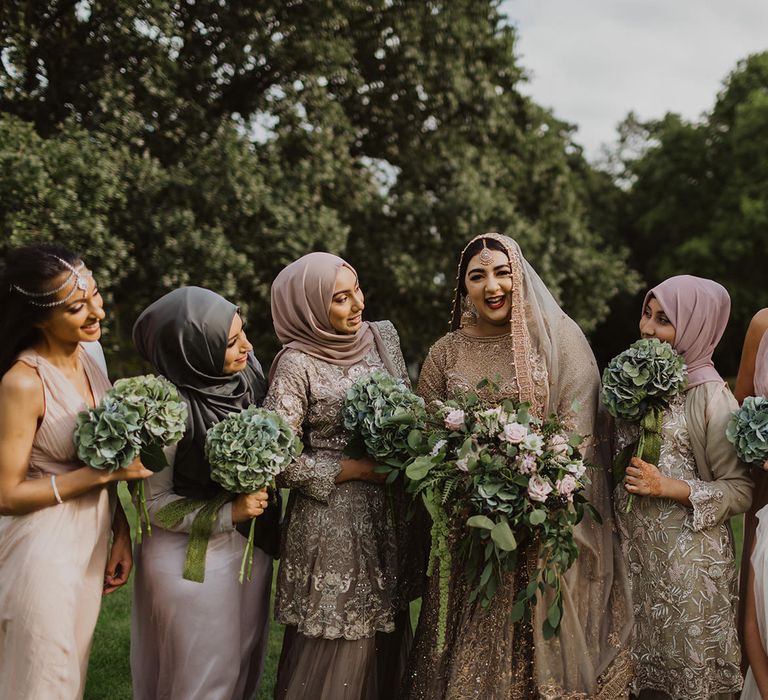 Bride in a gold dress with her bridesmaids 