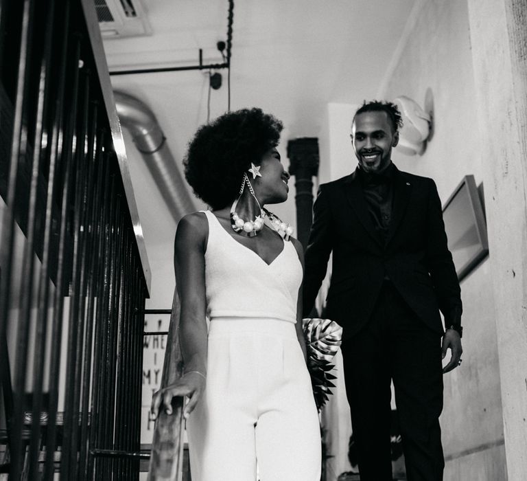 Bride & groom walking down the stairs 