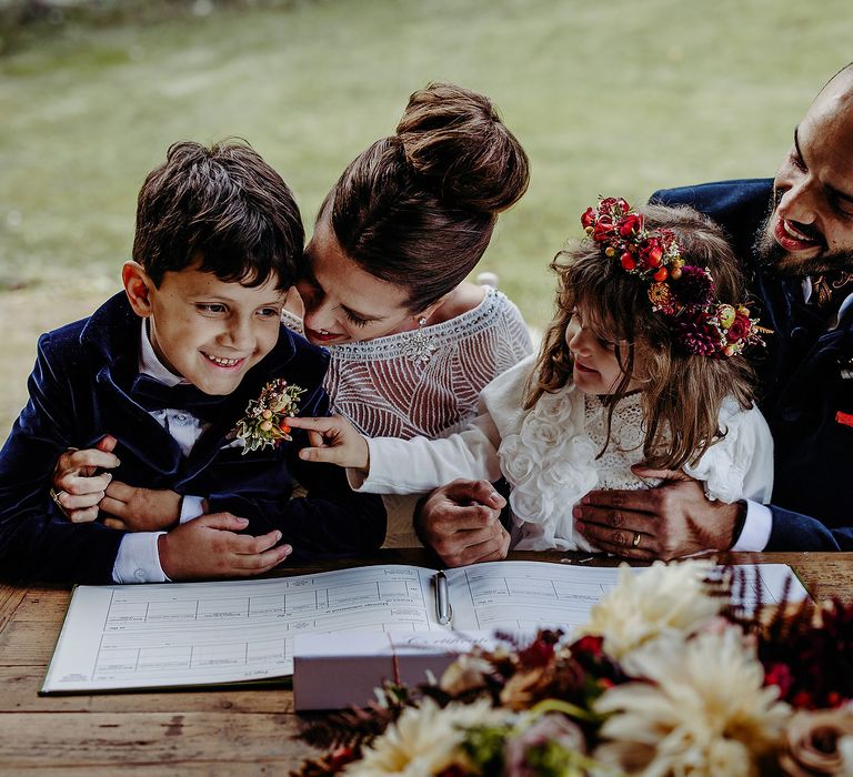 Bride & groom with their children during wedding ceremony