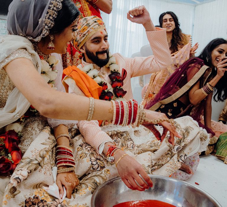 Wedding party laughing and smiling during Hindu ceremony