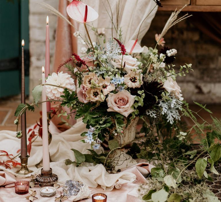 Romantic pink and green wedding flowers with anthuriums taper candles and votives