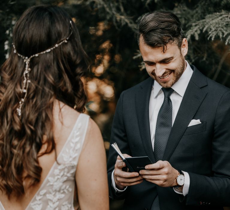 Groom reads his vows during wedding ceremony