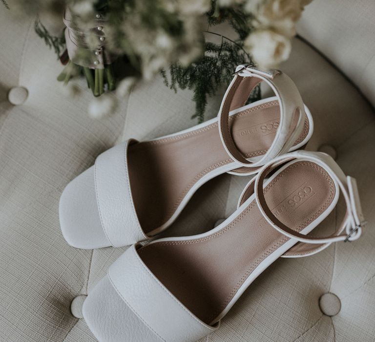 White asos block heeled sandal next to white rose wedding bouquet at Caswell House wedding