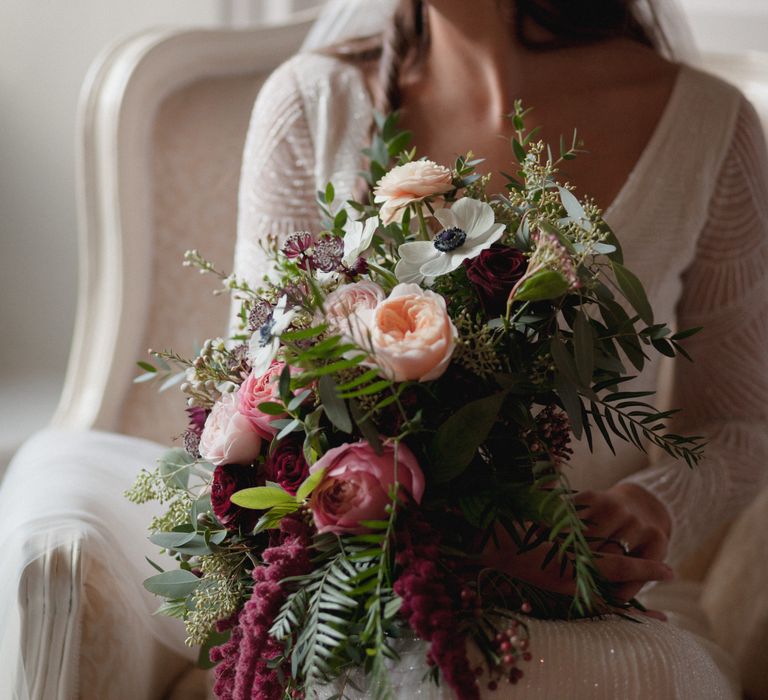 Bride to be on her wedding day holding berry, Peach and pink bridal bouquet 