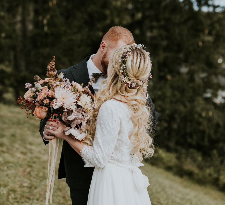 Bride and groom first look at Dolomites wedding with autumn bouquet and flower crown 