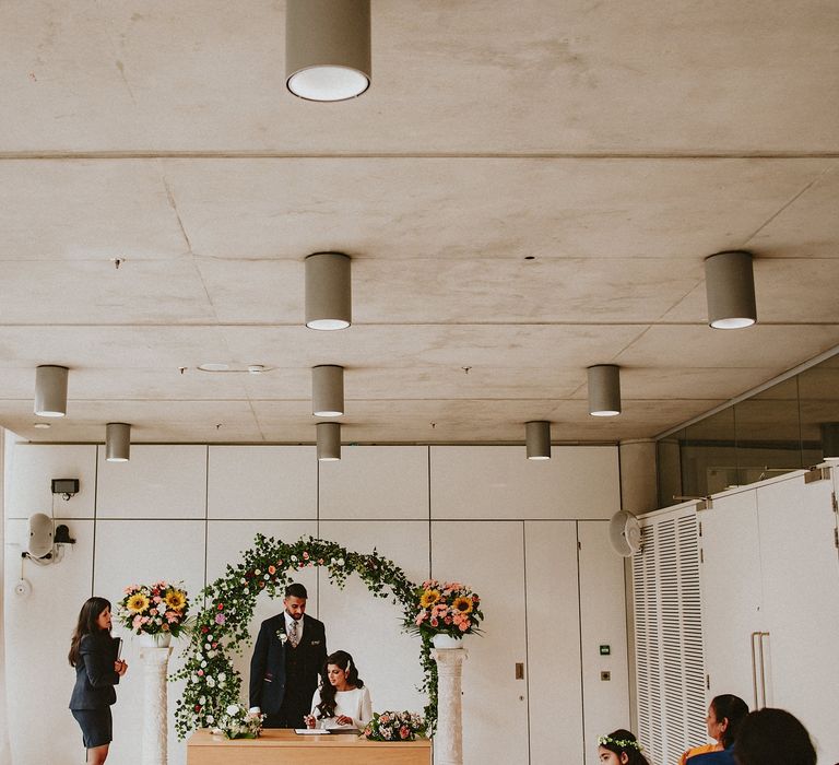 Foliage, sunflower and rose floral moon gate at Brent Civic Centre wedding venue 