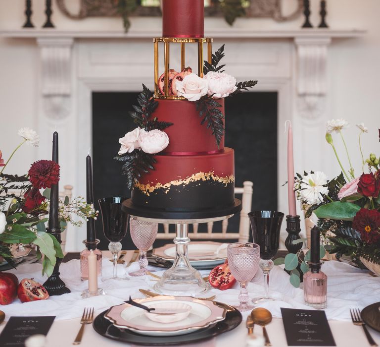 Three tier deep burgundy, black and gold elegant wedding cake for Pomegranate Noir autism marriage wedding inspiration 