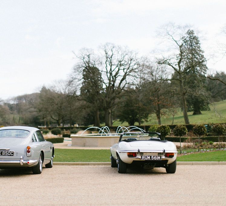 Classic wedding cars in the drive way of a country house wedding venue 