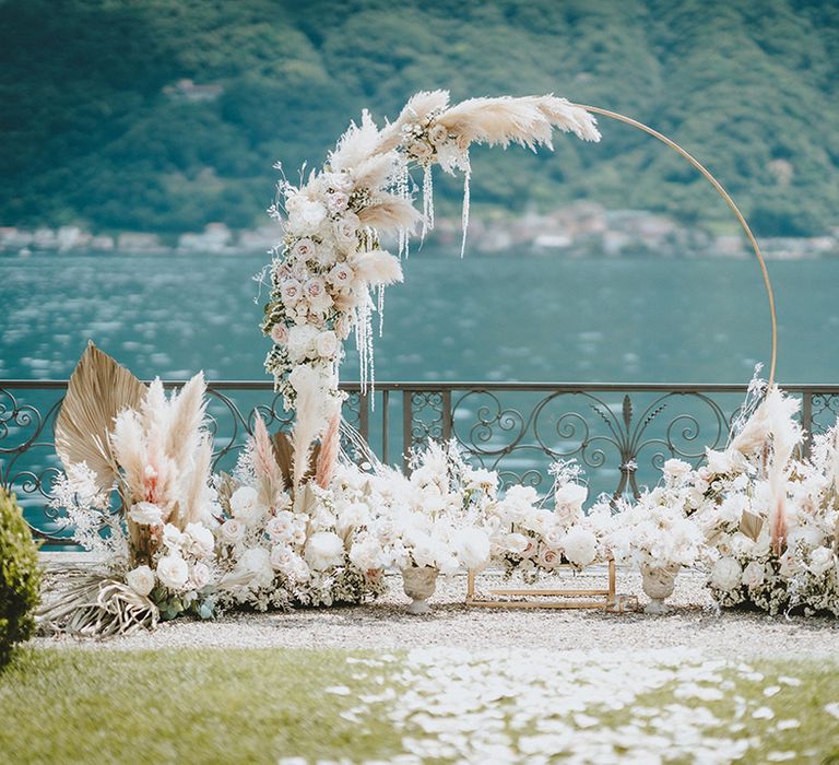 Pampas grass floral installation in front of Lake Como complete with neutral tones