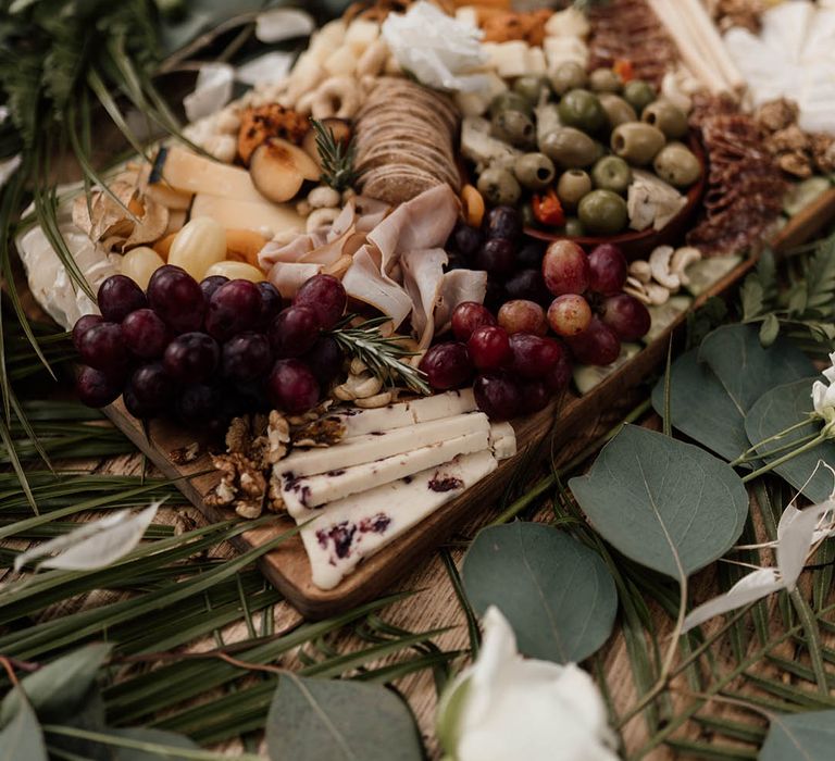 Fig & Fern grazing board with cheese, crackers, grapes, olives and nuts 