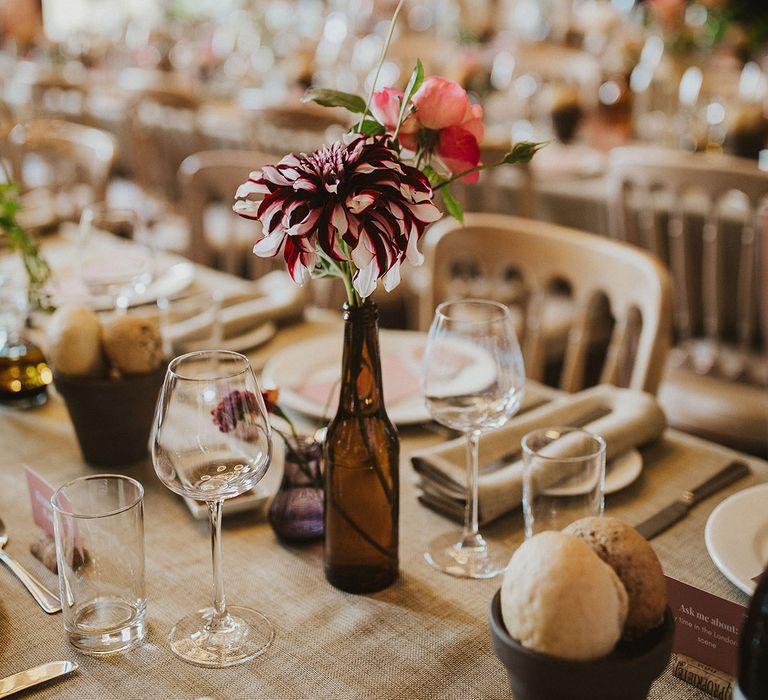 Rustic tablescape complete with florals and pink stationery