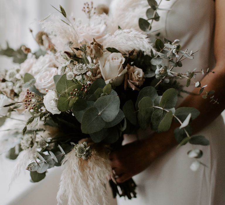 Bride holds her bridal bouquet on wedding day