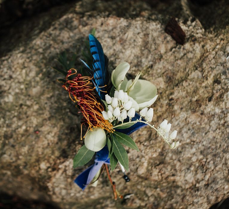 buttonhole flower with snowdrops and feathers 