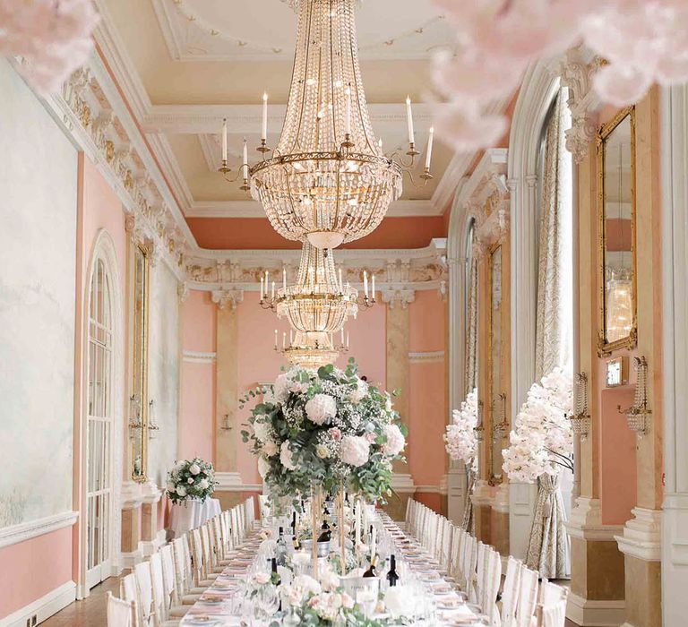 Versaille styled room complete with gold trims and blush pink colour scheme and grand hanging chandeliers 