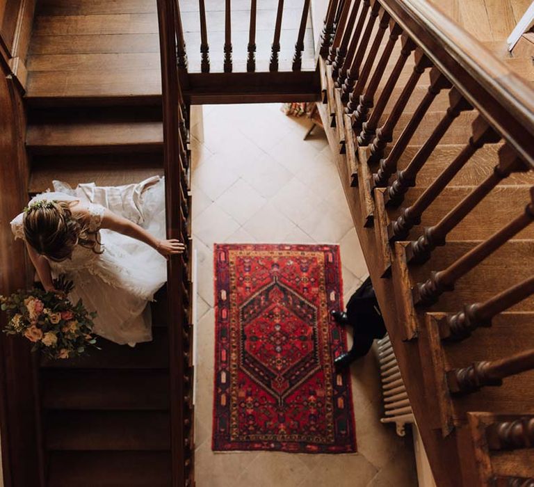 Bride in Madi Lane wedding dress walks down the stairs at Iscoyd Park