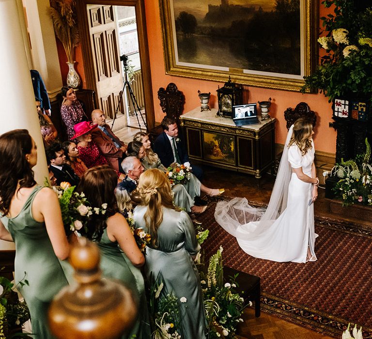 Bride and groom's wedding ceremony at Errol Park with bridesmaids stood on steps in sage green dresses