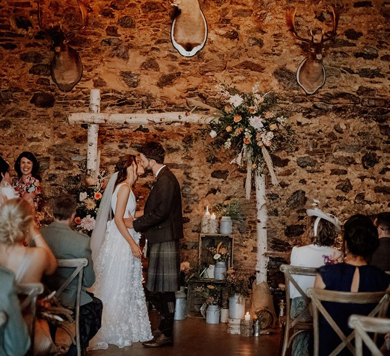 Bride and groom share their first kiss as husband and wife at rustic wedding venue Cardney Estate 