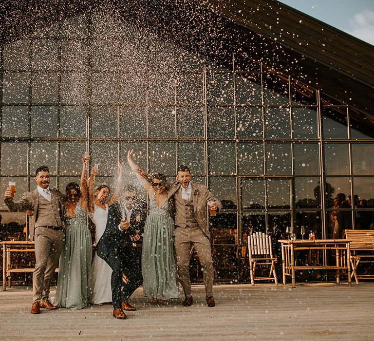 Wedding party photography popping champagne at Botley Manor