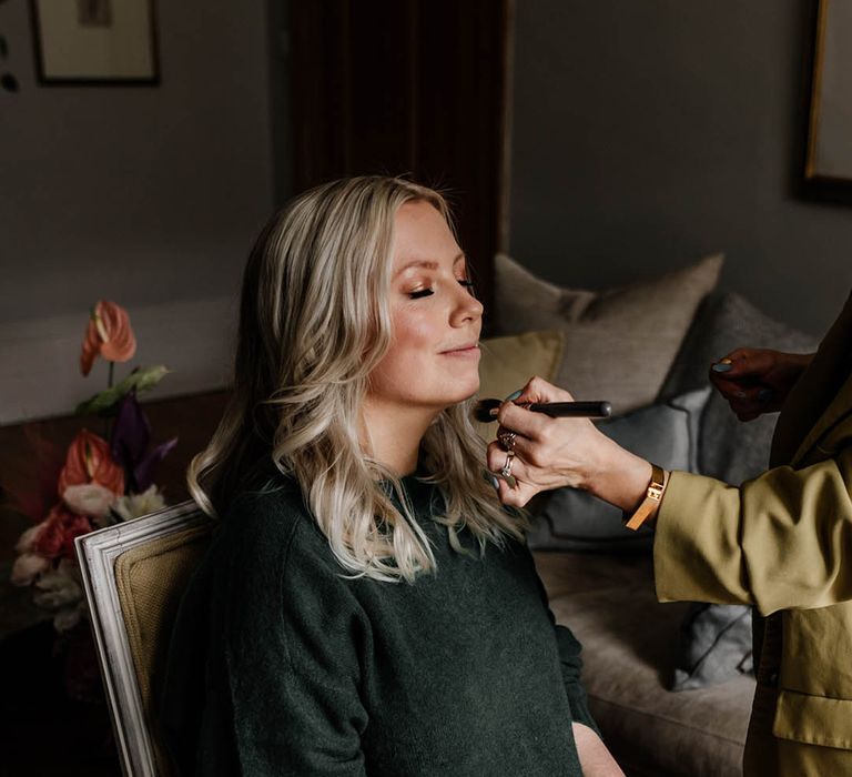 Bride on the wedding morning having her hair and makeup done