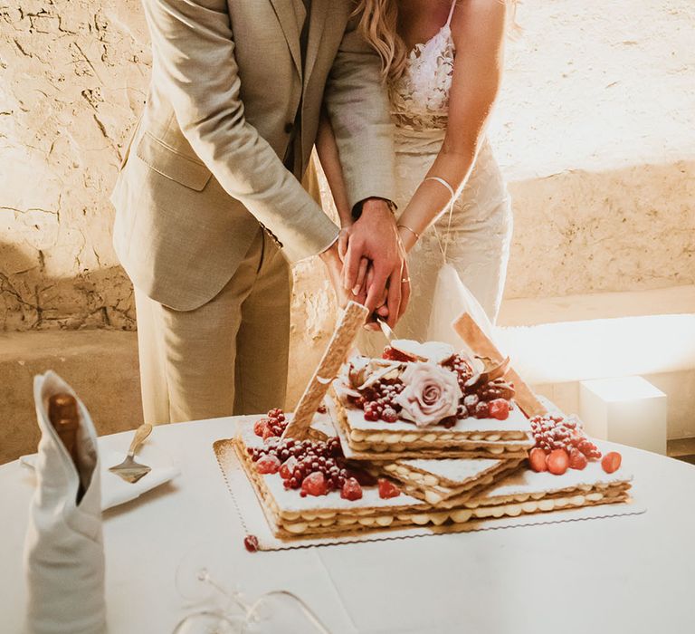 Traditional millefoglie filled with cream and decorated with florals, fresh berries and a dusting of icing sugar 