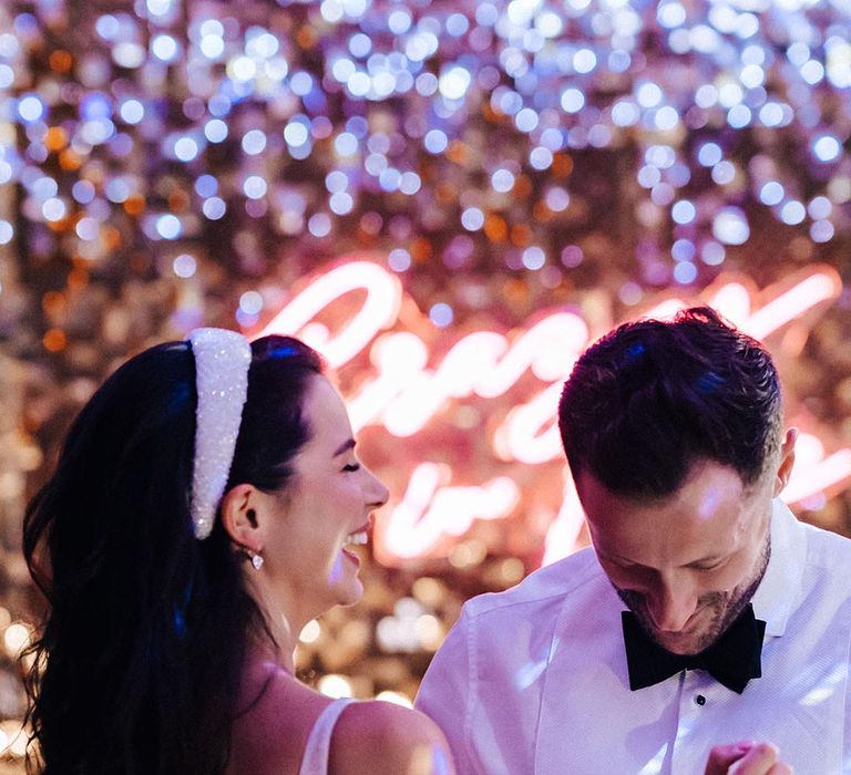 The bride and groom have changed into their reception outfits and share their first dance together 