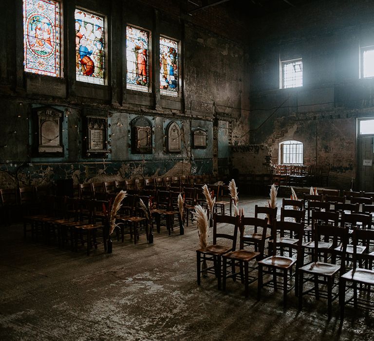 Pampas grass lines the aisle at unique London wedding venue, The Asylum Chapel