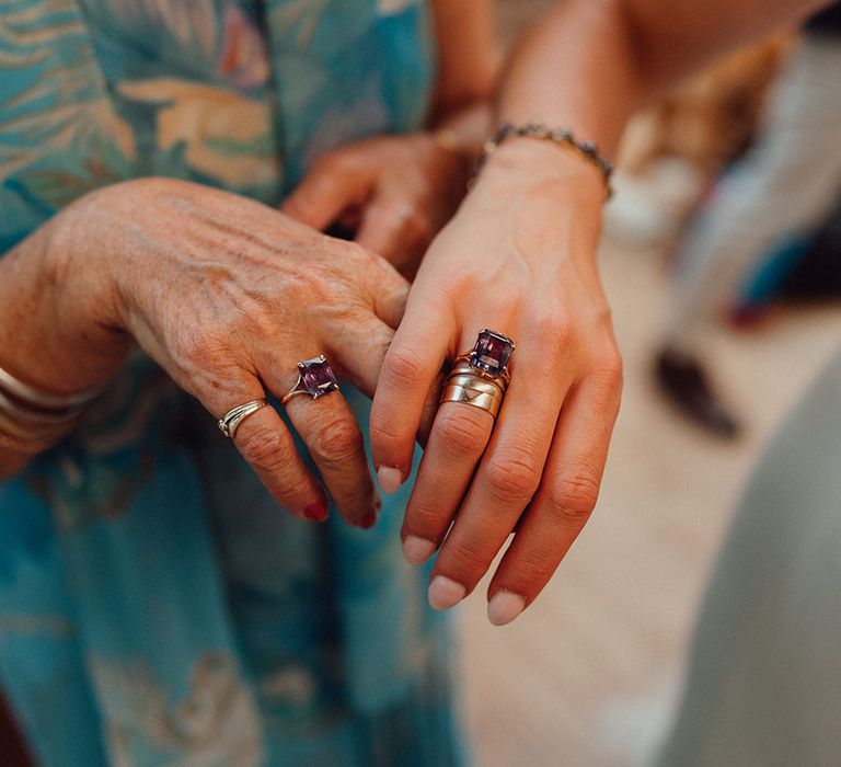 Bride and grandmother wear matching purple stoned emerald cut rings 