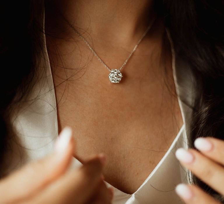 Dainty ball pendant diamond necklace worn by the bride in satin pyjamas 