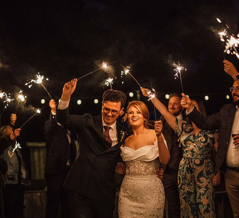 Bride & groom walk through sparkler exit 