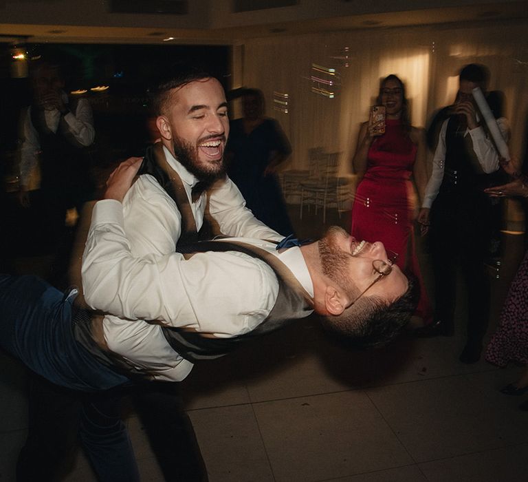 Grooms dancing during their evening reception at Hotel Cortijo Bravo, Vélez-Málaga, Málaga