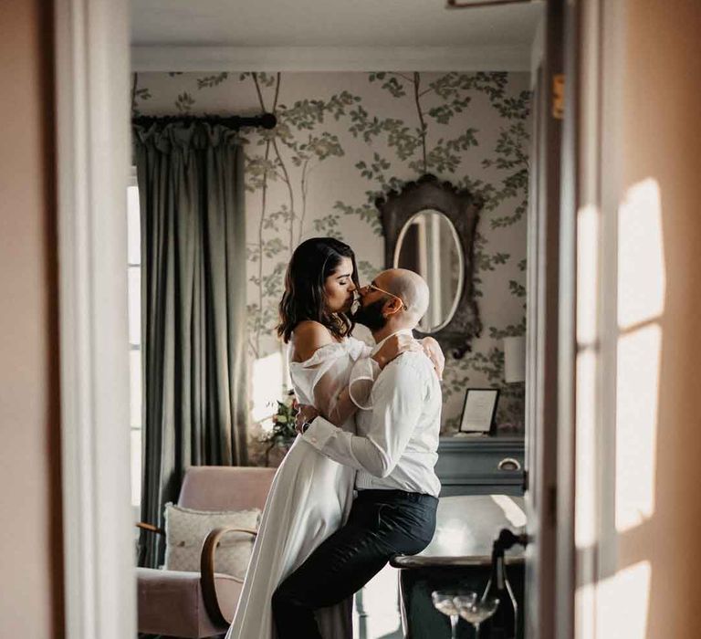 Bride and groom embracing in one of the function rooms at Elmley Nature Reserve - Kent wedding venue 