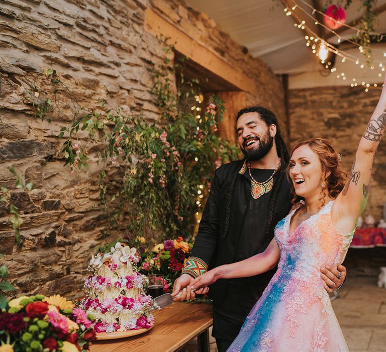 bride and groom cutting the wedding cake at their Deers Leap Retreat wedding reception