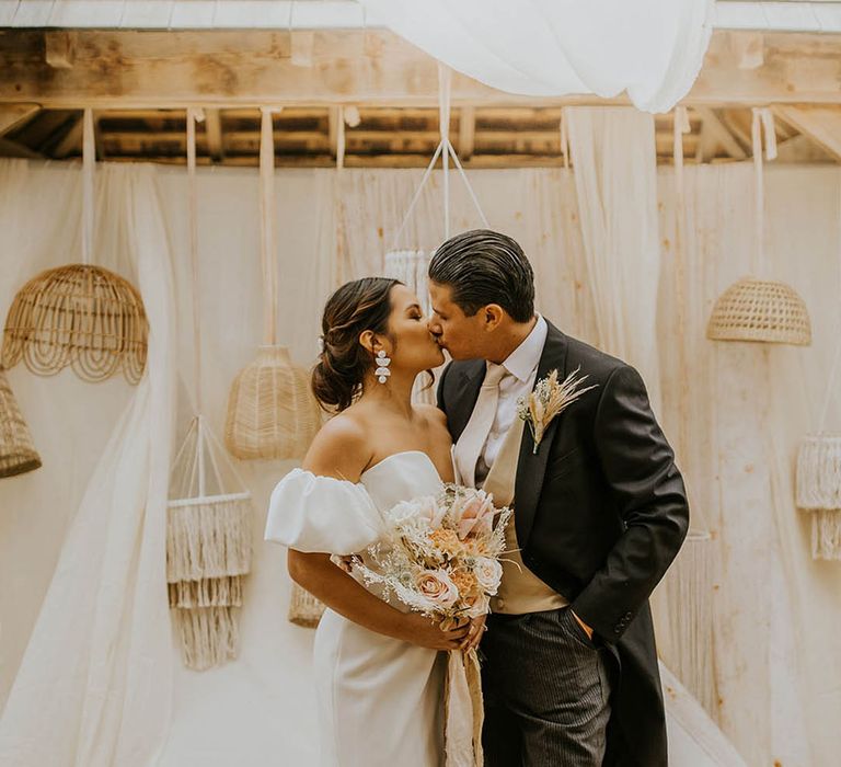 muted colour palette boho wedding inspiration at The Canary Shed with bride in a strapless wedding dress and groom in tails