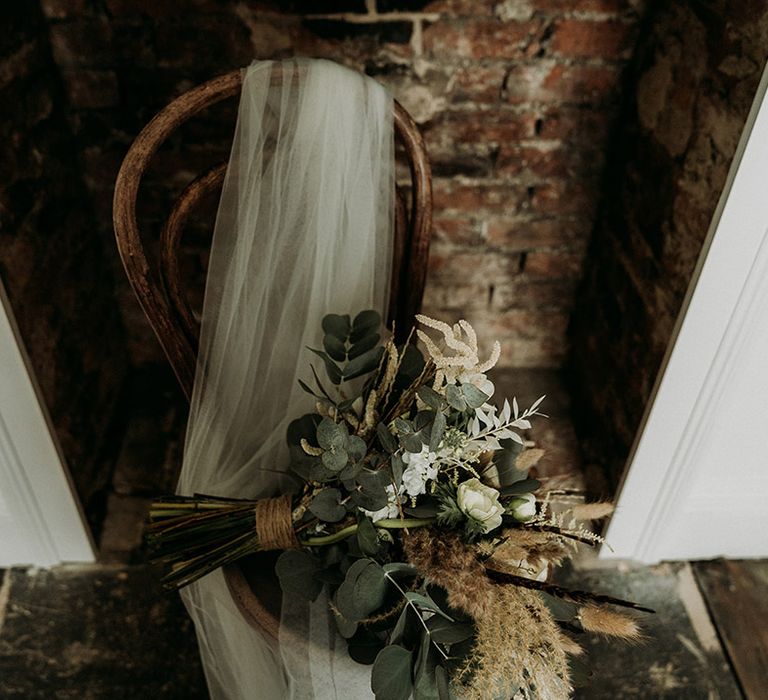 The bride's wedding veil and neutral wedding bouquet for the natural theme wedding at Aswarby Rectory 