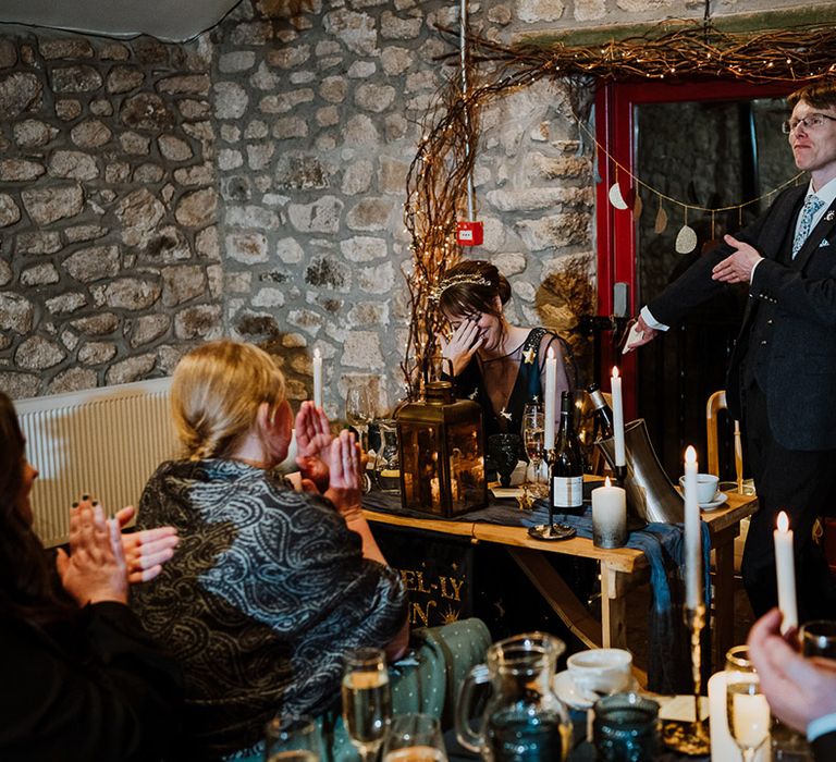 Groom stands up from the sweetheart top table to read out his groom speech 