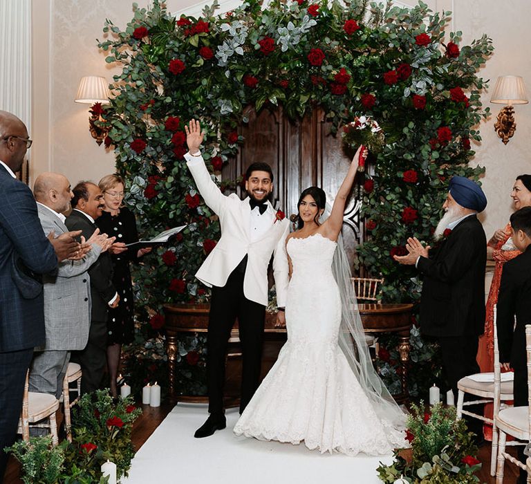 The bride and groom turn to face their guests as they are announced as husband and wife 