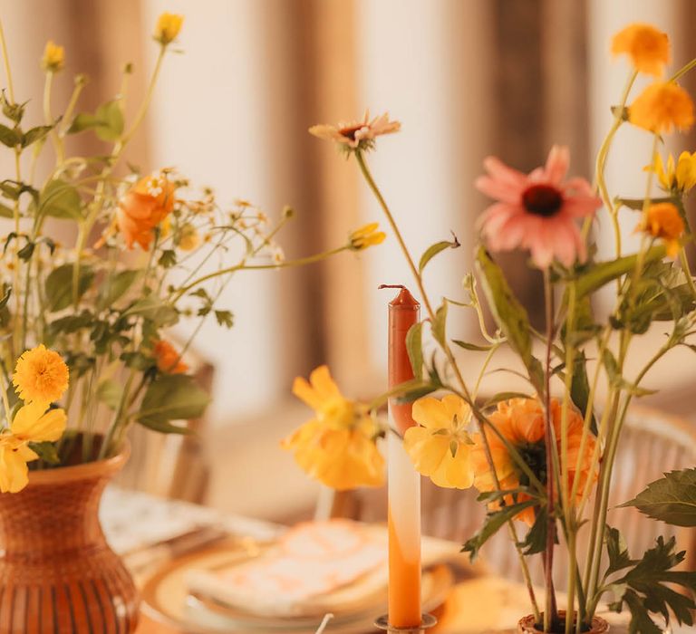 Orange and brown wedding decor and tablescape with vase of flowers 