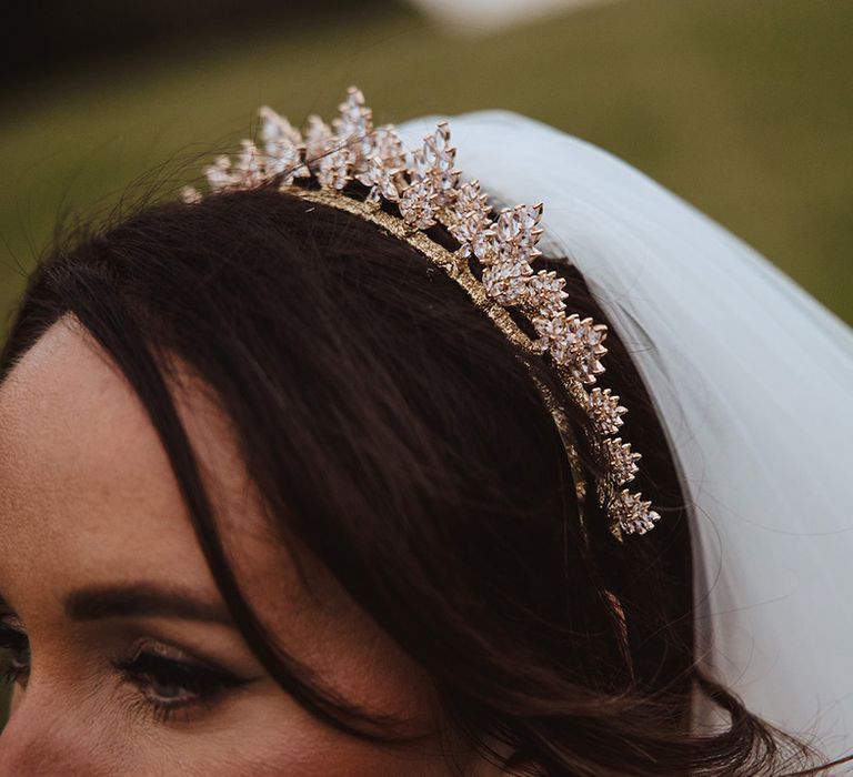 Bride wearing delicate gold sparkling crown tiara for classic country house wedding 