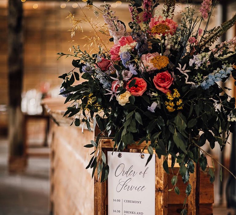 Order of service wedding sign with colourful flowers for wedding at The Cherry Barn 