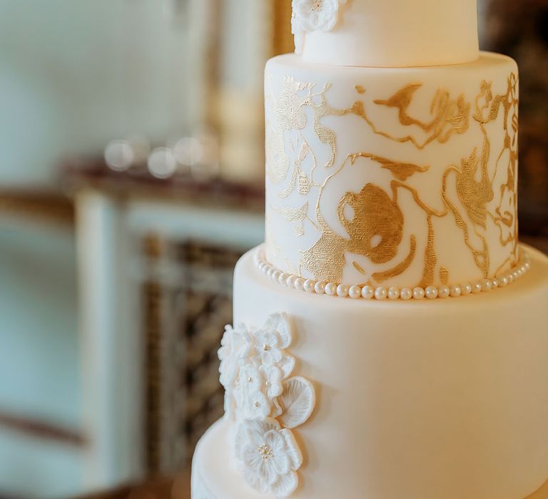 Classic three tier luxury wedding cake with gold detailing 